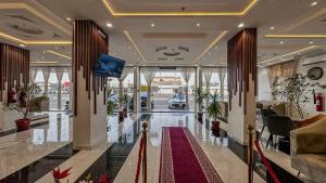 a lobby of a building with a red carpet at قصر لوماج - احد رفيدة in Ahad Rafidah