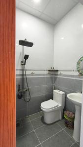 a bathroom with a toilet and a sink at Mango Homestay Hà Tiên in Hà Tiên +49 photos