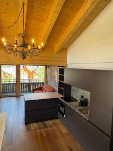 a kitchen with a bed in the middle of a room at Cesa Balzan in Canazei