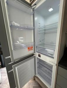 an empty refrigerator with its door open in a kitchen at SimpleStayHolland in Westerland