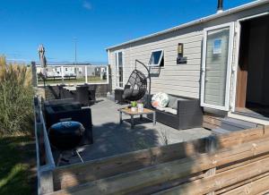 a patio with a grill and a smoker on a trailer at SimpleStayHolland in Westerland