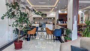 a restaurant with tables and chairs and a bar at قصر لوماج - احد رفيدة in Ahad Rafidah