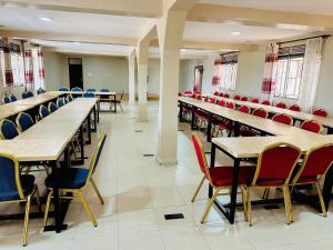 an empty classroom with tables and chairs at Ebenezer resort hotel in Mbale