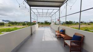 a balcony with chairs and a view of a field at Mango Homestay Hà Tiên in Hà Tiên