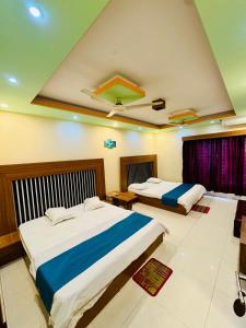 a bedroom with two beds in a room at Hotel Impulse Ocean View in Cox's Bazar
