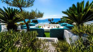 a resort with palm trees and a view of the ocean at VILLA MIAMI in Les Issambres