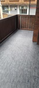 an empty patio with a wooden fence at Sofia Apartment - Aare Jungfrau AG in Wilderswil
