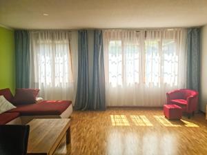 a living room with a couch and a chair at Sofia Apartment - Aare Jungfrau AG in Wilderswil +27 photos