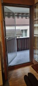 a sliding glass door with a view of a yard at Sofia Apartment - Aare Jungfrau AG in Wilderswil