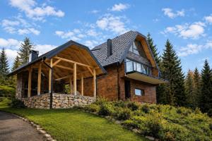 a brick house with a gambrel roof at Top Hill Vista in Sekulić 