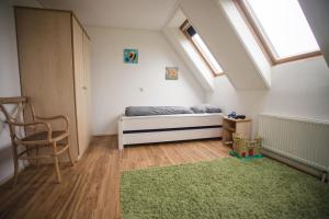 a bedroom with a bed and a green rug at Weidevilla 16 in Hollum