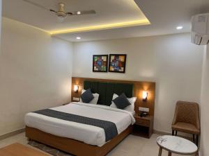 a hotel room with a bed and a chair at The Barrel House, Varanasi in Varanasi