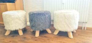 a group of three chairs sitting on top of a floor at Bussalp Apartment - Aare Jungfrau AG in Grindelwald +25 photos