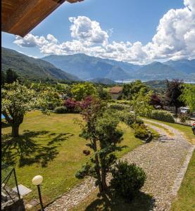 a view of a garden with mountains in the background at Fausta Lago in Colico