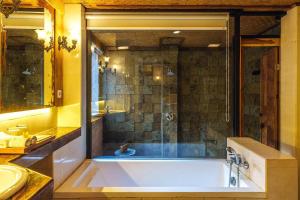 a large bathroom with a tub and a shower at Rama Phala Resort & Spa in Ubud
