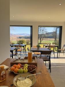 a table with a tray of fruit on top of it at Mable's BnB in Retreat +28 photos