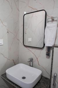 a bathroom with a sink and a mirror on a wall at Kunwarsa villa in Udaipur +14 photos