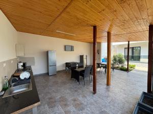 an open kitchen and dining room with a table at Vila SEA VIBES in Eforie Sud