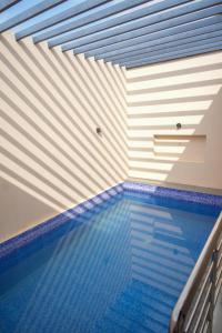 a swimming pool in a room with a ceiling at Kunwarsa villa in Udaipur