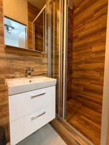 a bathroom with a sink and a shower at Penzión Daniel in Ilava