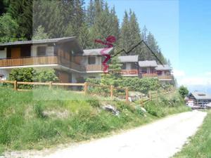 a house on a hill next to a dirt road at Chalet Zou Derri 3 in Les Collons