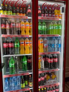 a refrigerator filled with lots of soda and sodas at Sharsharai Haftkul in Panjakent