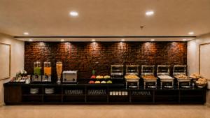 a bakery with a counter with food on it at Lime Tree Hotel & Banquet Jal Mahal Jaipur in Jaipur +9 photos