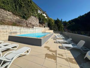 a row of lounge chairs and a swimming pool at Varandas do Gerês in Geres