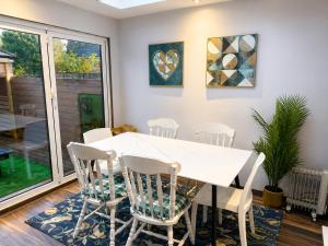 a dining room with a white table and chairs at Harwell Haven Large 4BR Home Garden & Parking in Chilton