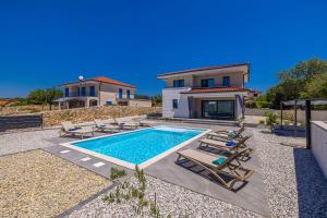 a villa with a swimming pool and a house at Villa ADRIA MOMENTS with private pool in Pinezici