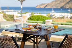 a table with a plate of food and drinks on it at Xerolithia in Kamares