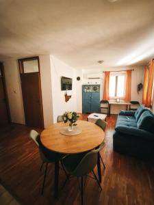 a living room with a table and a couch at Istrian old town apartment in Koper