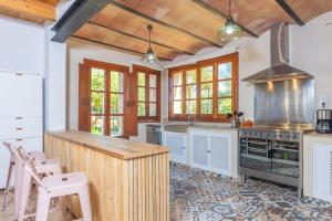 a kitchen with a counter and a stove top oven at Can Rosillo in Llucmajor