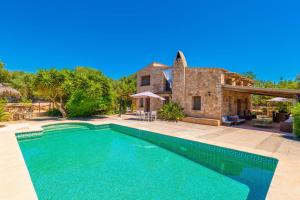 a villa with a swimming pool in front of a house at Can Rosillo in Llucmajor