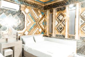 a bedroom with two beds and a wall covered in tiles at Hotel Minh Cường Trà Vinh in Nguyệt Hòa +207 photos