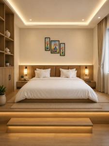 a bedroom with a large white bed and two lamps at Hotel shivay inn in Indore
