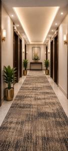 a hallway with a long carpet in a hotel lobby at Hotel shivay inn in Indore