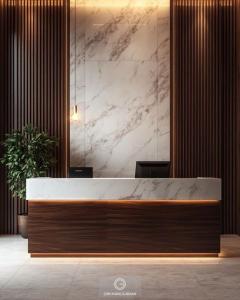 a reception desk in a lobby with a marble wall at Hotel shivay inn in Indore
