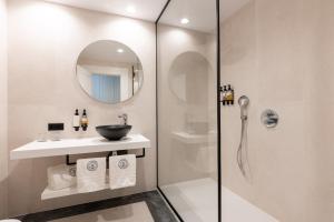 a bathroom with a shower and a sink and a mirror at Hotel Duquesa Golf Club in San Luis de Sabinillas +61 photos
