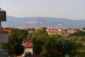 a view of a city with mountains in the background at Montecchio di Cortona in Cortona