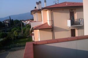 a building with a balcony with a view of a mountain at Montecchio di Cortona in Cortona