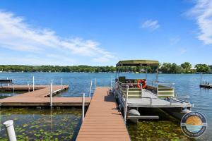 a boat is docked at a dock on a lake at 405 Waldeck Dr in Twin Lakes