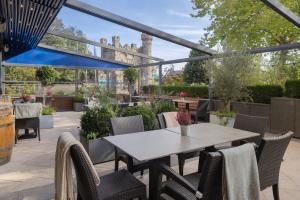 an outdoor patio with a table and chairs at Hilton Dublin Kilmainham in Dublin