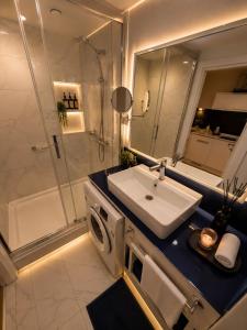 a bathroom with a sink and a shower at Seaside Studio at Orbi City in Batumi +15 photos