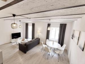 a living room with a couch and a table and chairs at Kenzingen Appartements zur Alten Brauerei in Kenzingen
