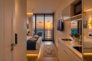 a hotel room with a bed and a view of the ocean at Seaside Studio at Orbi City in Batumi