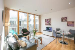 a living room with a couch and a table at IFSC Townhouse Apartments in Dublin