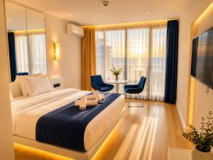a hotel room with a bed and a table and chairs at Seaside Studio at Orbi City in Batumi