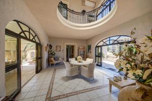 an open living room with a table and chairs at Valleyside Heights Residence - Pool & Heated Jacuzzi in Is-Swieqi