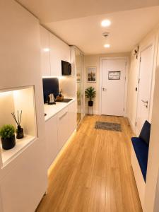 a hallway with a kitchen and a living room at Seaside Studio at Orbi City in Batumi